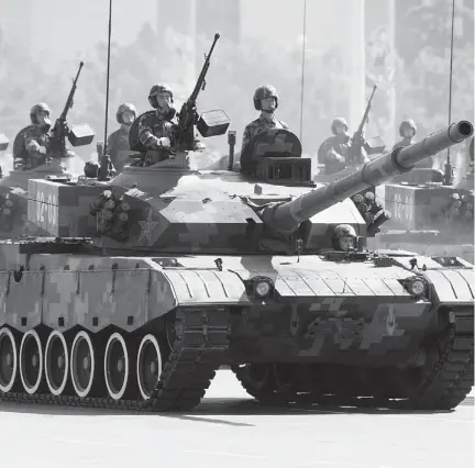  ?? NELSON CHING / BLOOMBERG NEWS ?? Chinese People’s Liberation Army tanks move down Changan Avenue during a military parade in Beijing in 2009.