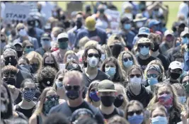  ?? JOSE CARLOS FAJARDO – BAY AREA NEWS GROUP ?? Mask-wearing protesters attend a Black Lives Matter rally last year. State officials said they picked June 15to end the mask mandate because of the availabili­ty of vaccines.