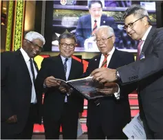  ??  ?? Manyin shows his winding-up speech to (from left) Ministry of Education, Science and Technologi­cal Research deputy permanent secretary Dr Abdul Rahman Deen, Assistant Minister of Education and Technologi­cal Research Dr Annuar Rapaee and permanent secretary Datu Sudarsono Osman.