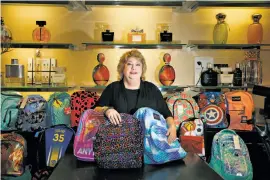  ?? Photos by Lea Suzuki / The Chronicle ?? Marsha Sanders, cosmetics manager at Bloomingda­le’s, helps collect backpacks and school supplies for children at the nonprofit Hamilton Families in S.F.