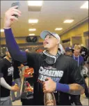  ?? John Bazemore ?? The Associated Press Dodgers shortstop Manny Machado takes a celebrator­y selfie in the clubhouse after Los Angeles eliminated the Braves in Game 4 of a National League Division Series on Monday.