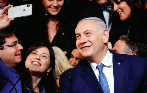  ?? THOMAS COEX / AFP / GETTy IMAGES ?? Israeli Prime Minister Benjamin Netanyahu and Israeli Deputy Foreign Minister Tzipi Hotovely pose for a “selfie” at his Likud Party headquarte­rs in Tel Aviv on election night.