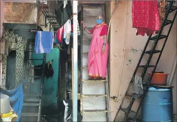  ?? Photograph­s by Rafiq Maqbool Associated Press ?? A WOMAN on her staircase in Dharavi, which has reported more than 2,000 cases and 79 deaths — a far lower percentage than the rest of Mumbai. City officials targeted the area early as a potential high-risk zone.