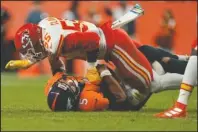  ?? The Associated Press ?? GOING DOWN: Denver Broncos quarterbac­k Joe Flacco (5) is sacked by Kansas City Chiefs defensive end Frank Clark (55) during the first half of Thursday’s game in Denver.