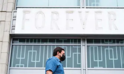  ?? Photograph: Justin Lane/EPA ?? A man walks past a shuttered business in New York City.