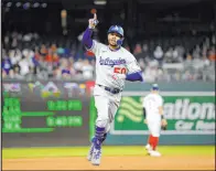  ?? Nick Wass The Associated Press ?? Dodgers’ Mookie Betts celebrates his home run as he rounds the bases during the fourth inning against the Washington Nationals Tuesday at Nationals Park.