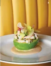  ??  ?? An avocado cradles shrimp salad on a pool of Marie Rose sauce