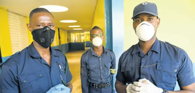  ??  ?? Members of the Department of Correction­al Services wearing face masks during a tour of the Horizon Adult Remand Centre in Kingston on Friday.