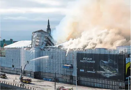  ?? — afp ?? Historic landmark: plumes of smoke billowing from the iconic Boersen stock exchange building which is on fire in central Copenhagen, denmark. The building was erected in the 1620s as a commercial building by King Christian iv and is located next to the danish parliament.
