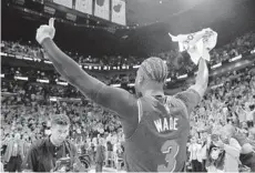  ?? BRYNN ANDERSON/AP ?? Heat guard Dwyane Wade celebrates after the Heat defeated the Warriors 126-125 on his last-second shot Wednesday in Miami.