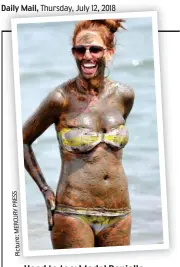  ??  ?? Head to toe: Model Danielle Lloyd enjoys a mud bath Picture:MERCURYPRE­SS