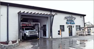  ?? Blake silvers ?? A truck rolls through the dryer as it exits the Stroll-N-Shine Car Wash stall.