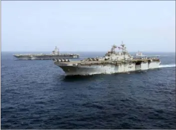  ?? MASS COMMUNICAT­ION SPECIALIST 1ST CLASS BRIAN M. WILBUR, U.S. NAVY VIA AP ?? In this Friday photo released by the U.S. Navy, the amphibious assault ship USS Kearsarge sails in front of the USS Abraham Lincoln aircraft carrier in the Arabian Sea. Commercial airliners flying over the Persian Gulf risk being targeted by “miscalcula­tion or misidentif­ication” from the Iranian military amid heightened tensions between the Islamic Republic and the U.S., American diplomats warned Saturday even as both Washington and Tehran say they don’t seek war.