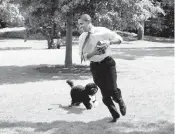  ?? PETE SOUZA/THE WHITE HOUSE 2009 ?? President Barack Obama plays football with Bo on the South Lawn of the White House.