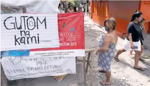  ?? PHOTO BY RUY L. MARTINEZ ?? ‘HUNGER GAMES’
Residents from a depressed area of Pasong Tamo in Quezon City on Tuesday hang up a sign that reads ‘Gutom na kami ( We are hungry),’ as they wait for the promised relief from the local and national government­s amid an enhanced community quarantine due to the Covid-19 pandemic.