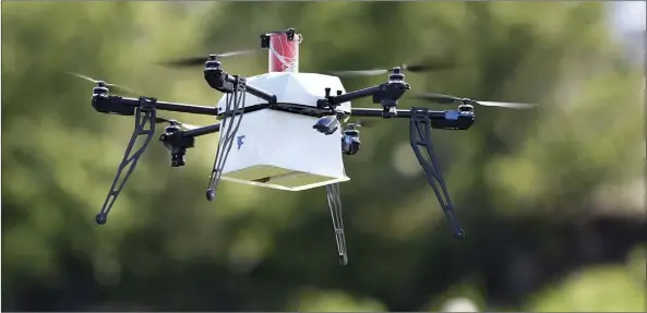  ?? AP FILE PHOTO/MEL EVANS ?? A drone aircraft with a payload of simulated blood flies during a ship-to-shore delivery simulation in Lower Township, N.J. on June 22, 2016. With the number of commercial drones expected to soar into the millions in the next few years, it spells an...