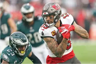  ?? AP Photo/Mark LoMoglio ?? Tampa Bay Buccaneers wide receiver Mike Evans (13) pulls in a reception in front of Philadelph­ia Eagles safety Rodney McLeod (23) Sunday during the second half of an NFL wild-card football game in Tampa, Fla.