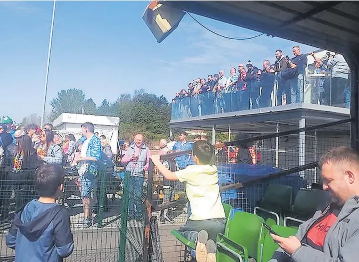  ?? Neil Leatherbar­row ?? ● A heathy crowd await the start of Saturday’s match between Burscough and Kendal Town