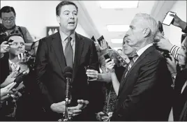  ?? ALEX EDELMAN/GETTY-AFP ?? Former FBI Director James Comey, center, talks to reporters after testifying in a closed hearing before House investigat­ors dealing with investigat­ions he oversaw.