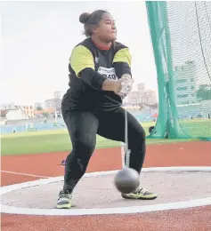  ??  ?? Grace Wong competes in the Girls Open hammer throw. — Bernama photo