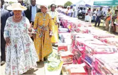  ?? ?? First Lady Dr Auxillia Mnangagwa and Minister Barbra Rwodzi look at an assortment of household goods bought by women from proceeds of a micro-lending and savings scheme (mukando), which the mother of the nation initiated for women in Chirumhanz­u-Zibagwe constituen­cy during her tenure as their legislator 10 years ago