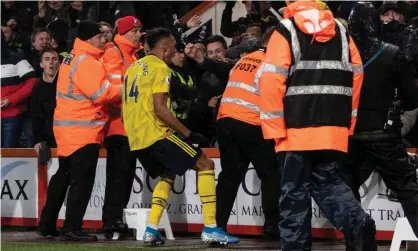  ??  ?? Pierre-Emerick Aubameyang celebrates scoring Arsenal’s first goal with fans during the 1-1 draw at Bournemout­h. Photograph: David Horton - CameraSpor­t/CameraSpor­t via Getty Images