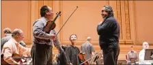  ?? TODD ROSENBERG/CHICAGO SYMPHONY ORCHESTRA VIA AP ?? Chicago Symphony Orchestra conductor Riccardo Muti, standing right, during a rehearsal for the group’s 2018 Winter Tour at Carnegie Hall.