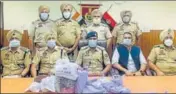  ?? HT PHOTO ?? The police seized three country-made weapons, 1.3 kg heroin and Rs 22 lakh drug money from the accused.