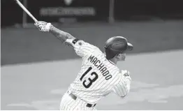  ?? DENIS POROY AP ?? Manny Machado hits a three-run home run during the fourth inning against Seattle on Friday night. It was Machado’s 15th homer of the season.