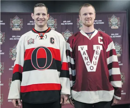  ?? JANA CHYTILOVA/OTTAWA CITIZEN ?? Senators’ centre Jason Spezza and Henrik Sedin of the Vancouver Canucks unveil the sweaters the teams will wear during the 2014 Heritage Classic at Vancouver’s BC Place next March. Sens president Cyril Leeder is in talks with the league about holding...