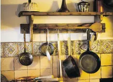  ?? GETTY IMAGES/ISTOCKPHOT­O ?? If you’re short on cabinet and drawer space, consider hanging pots from a wall-mounted or ceiling-mounted pot rack.