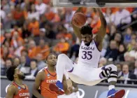  ?? Associated Press ?? ■ Kansas' Udoka Azubuike (35) dunks as Clemson's Gabe DeVoe, left, and Aamir Simms watch during the second half of a regional semifinal game in the NCAA men's college basketball tournament Friday in Omaha, Neb. Kansas won, 80-76.