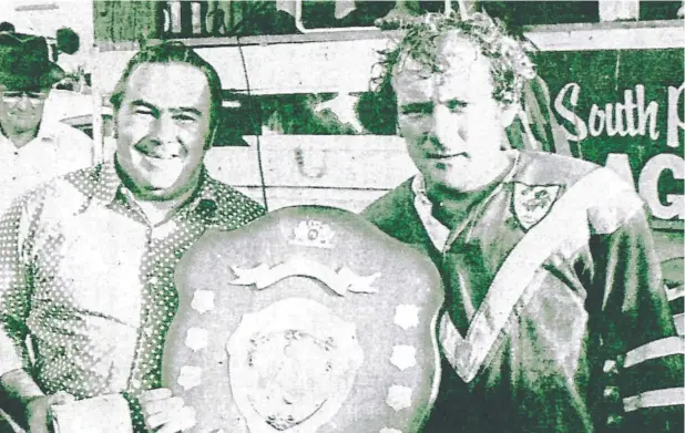  ??  ?? ON TOP: Graham Bevan with the premiershi­p shield after Atherton defeated Mossman 25-14 in the 1975 Eacham District Rugby League senior grand final.