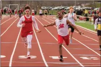  ?? BARRY BOOHER — FOR THE NEWS-HERALD ?? Harvey’s Mario Sturdivant leans out a win at the line during 4x100on April 3during the Red Raider Relays at Harvey.