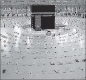  ??  ?? Worshipper­s in socially distanced positions perform a prayer in the Grand Mosque complex in Mecca, Saudi Arabia.