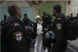  ?? MAHMOUD ILLEAN — THE ASSOCIATED PRESS ?? Israeli police argue with a Palestinia­n worshipper in the Old City of Jerusalem on Sunday.