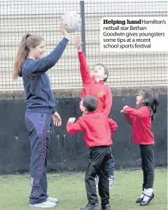  ??  ?? Helping handhamilt­on’s netball star Bethan Goodwin gives youngsters some tips at a recent school sports festival