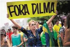  ?? AP ?? Out-of-office message A woman with a ‘Dilma out’ sign during a demonstrat­ion on Sunday for the impeachmen­t of Brazil’s president.