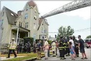  ?? DANA JENSEN/THE DAY ?? Firefighte­rs at the scene of a structure fire at Bulkeley Place and Prospect Street on Friday in New London.