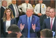  ?? AP PHOTO/SETH WENIG ?? Former President Donald Trump, center, speaks Monday upon arriving at New York Supreme Court in New York.