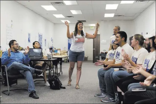  ?? JASON OGULNIK/LAS VEGAS REVIEW-JOURNAL ?? Lucy Flores, center, candidate for the state’s 4th Congressio­nal District, talks to canvassers at her office in North Las Vegas Saturday.