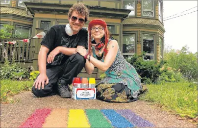  ?? MILLICENT MCKAY/JOURNAL PIONEER ?? Andrew Birch, left, and Meaghan Roberts are shown with their finished rainbow on the porch step of a Summerside home. The duo has been spraypaint­ing rainbows on porches and driveways to encourage acceptance in Summerside.