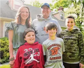  ?? Brian A. Pounds/Hearst Connecticu­t Media ?? Conner Curran, 12, lower left, with his parents Christophe­r and Jessica, and brothers Kyle, 12, right, and William, 10, at their home in Ridgefield, Connecticu­t, last week. Conner is receiving gene therapy treatment for his Duchenne’s muscular dystrophy.