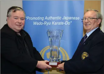  ??  ?? Councillor Paul Bell on his last day of service as an elected public representa­tive receives a presentati­on from Philip Nulty Chairperso­n of the Drogheda School of Karate-Do-Wado-Kai in recognitio­n of the years of support he gave to the club.