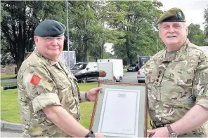  ??  ?? Brigadier John Thomson, right, presents a certificat­e of merit to Sgt Maj Instructor Paul Brentnall of Frodsham for 14 years service