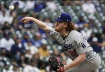  ?? MORRY GASH
AP PHOTO/ ?? Los Angeles Dodgers’ Dustin May throws during the first inning of a baseball game against the Milwaukee Brewers Saturday, May 1, in Milwaukee.