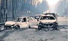  ??  ?? Vehículos calcinados quedaron ayer en medio de la carretera cercana al incendio forestal en la localidad de Pedrogao Grande, Portugal.