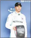  ?? (AP) ?? Mercedes driver Lewis Hamilton of Britain poses with the pole position award after getting the pole for the Japanese Formula One Grand Prix at the Suzuka Circuit in Suzuka,central Japan, Oct 6.