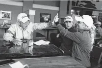  ?? Jason Fochtman / Staff photograph­er ?? Montgomery coach Kirk Thomason gives Kimberly Tiefenbach a high-five after the team learned it would medal at state.