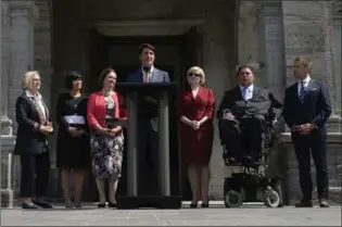  ?? ADRIAN WYLD, THE CANADIAN PRESS ?? Prime Minister Justin Trudeau talks to the media with some members of his newly- shuffled cabinet.